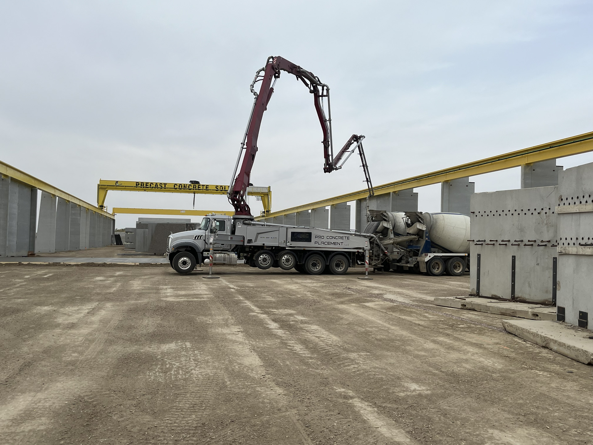 Concrete boom pump operating at a precast facility
